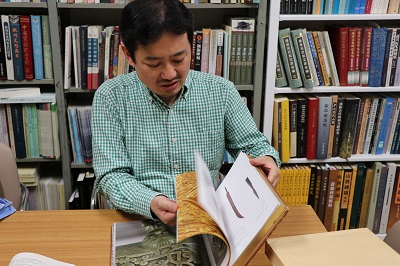 Associate Professor Funada looking through historical materials.