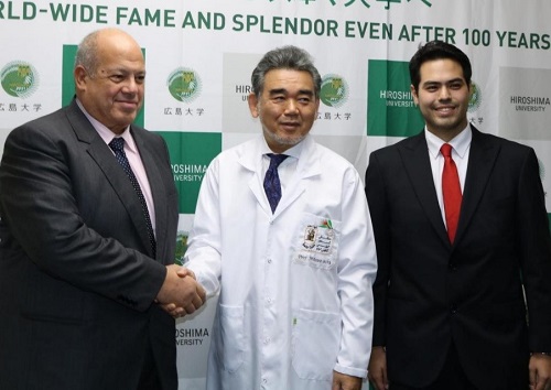 Mr. Rashwan shaking hands with President Ochi who was wearing the same white robe he used at Cairo University