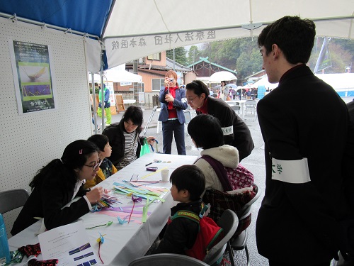 Intern Students Working in the International Exchange Practicum in the Tent