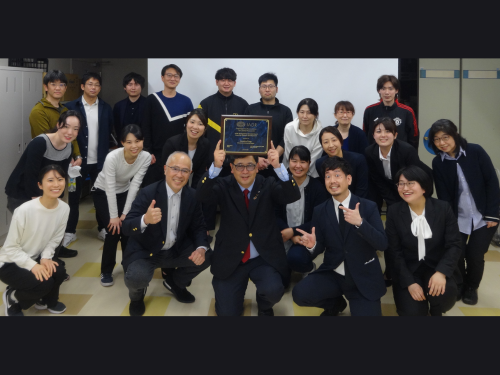 HU Executive VP Tsuga posing with his IADR award plaque along with researchers in his laboratory